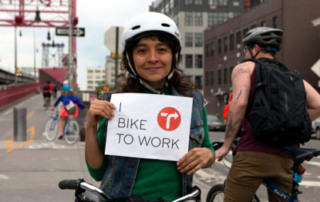 girl holding bike to work sign