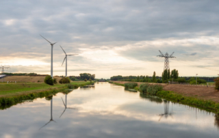 A river that flows through a windmill farm