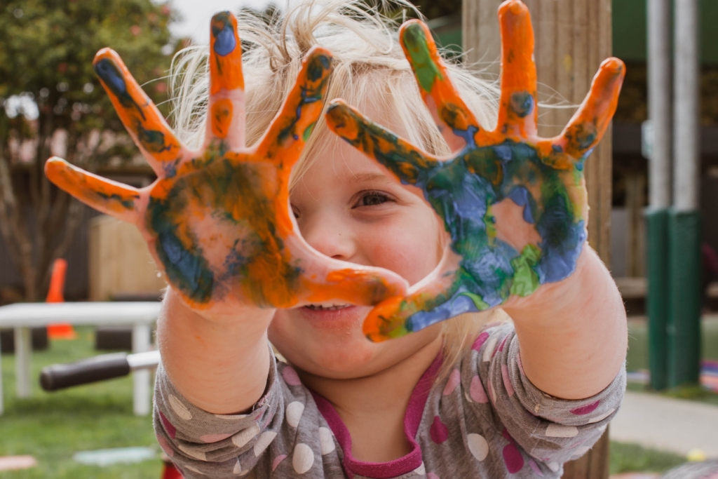A child with paint on their hands