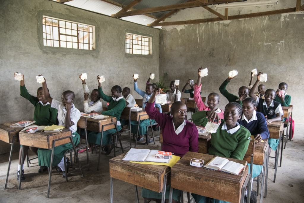 School children in Kenya raising their hands