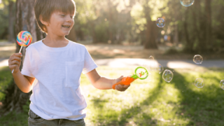 Close-up of children holding a planet at the beach