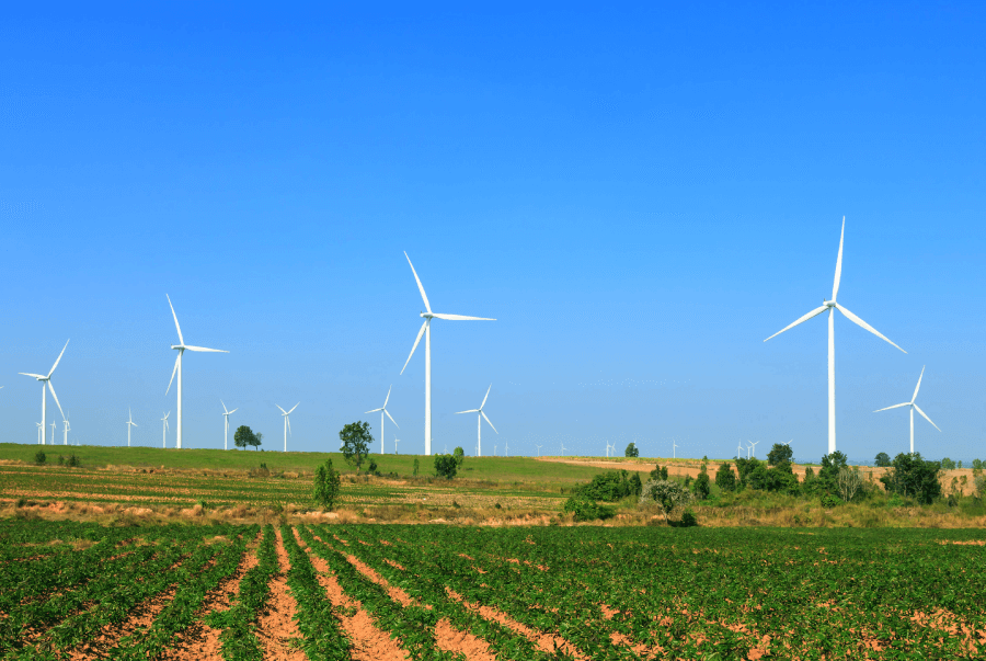 An open windmill over a crop farm