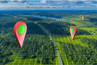 A question mark sign in lush green grass on a cloudscape background